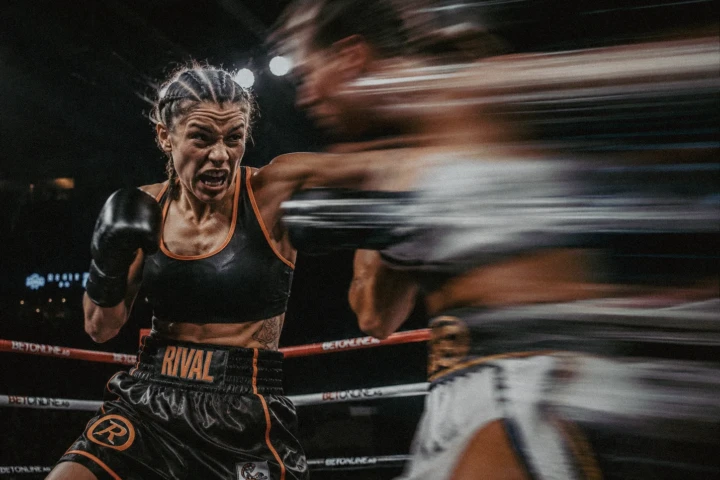 Female boxer competing during a fast-paced women’s boxing match in Dubai