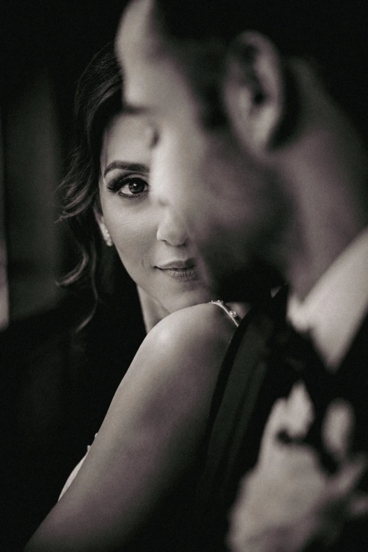 Afghan bride looking toward the camera from behind the groom during an artistic wedding portrait in Istanbul
