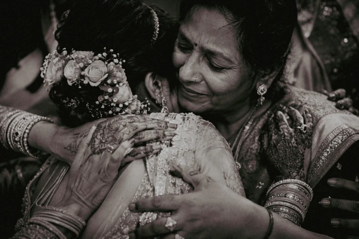 Indian bride embracing her emotional mother during a wedding farewell moment in Dubai.