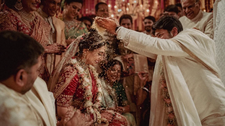 indian wedding photographer , Family member showering an Indian bride with rice during a traditional wedding ceremony in Dubai.