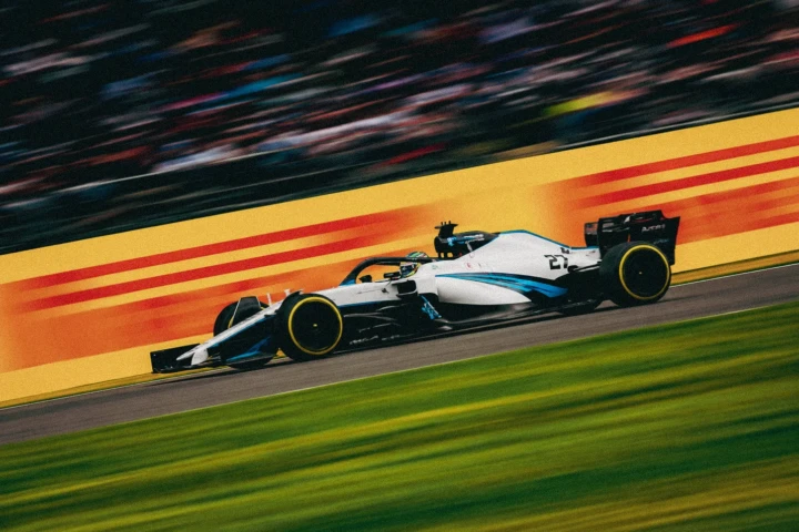 Single-seater formula racing car travelling at high speed on a professional race circuit