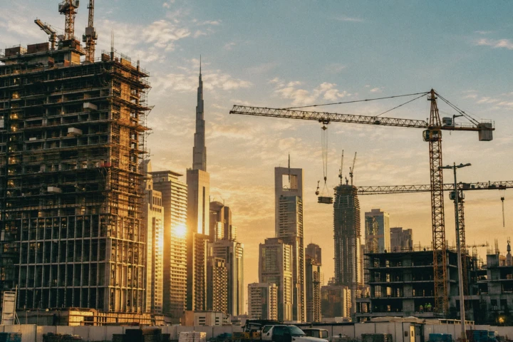 High-rise construction projects, tower cranes and the Dubai skyline with Burj Khalifa during construction progress photography in Dubai, UAE.